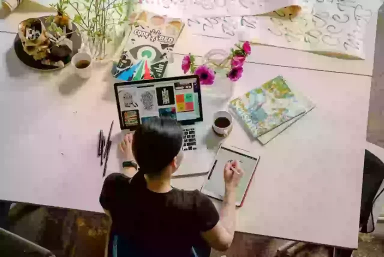 Person working at a creative desk setup.