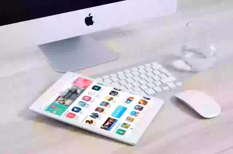 Apple iMac, keyboard, mouse, and iPad with apps.