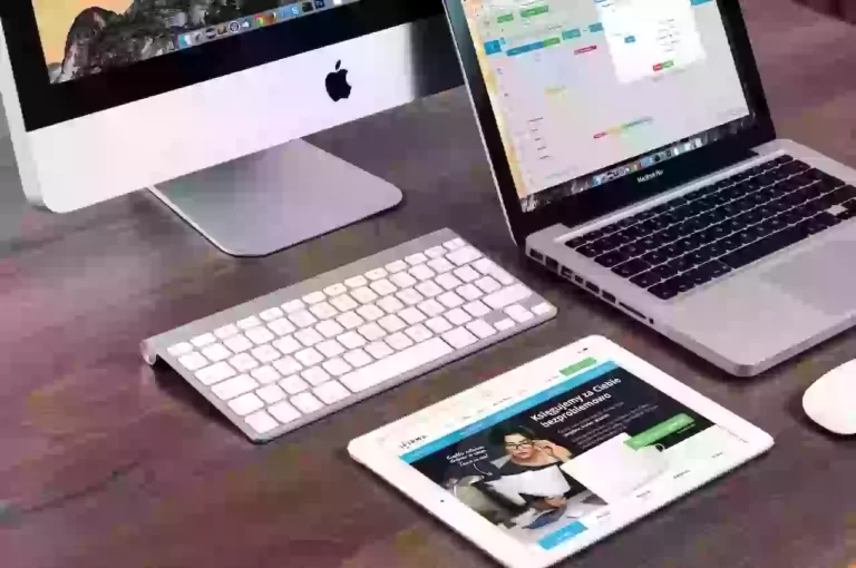 Apple devices: iMac, MacBook, iPad on desk.